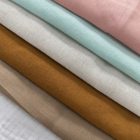 Vải cotton Hàn là gì? Ưu điểm, ứng dụng và cách chọn đúng loại 8 Các mẫu màu vải linen được trải xòe như quạt trên bàn trưng bày.